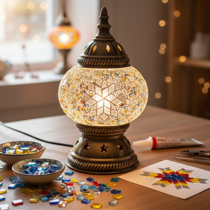 Decorative lamp with mosaic design on a table with craft materials