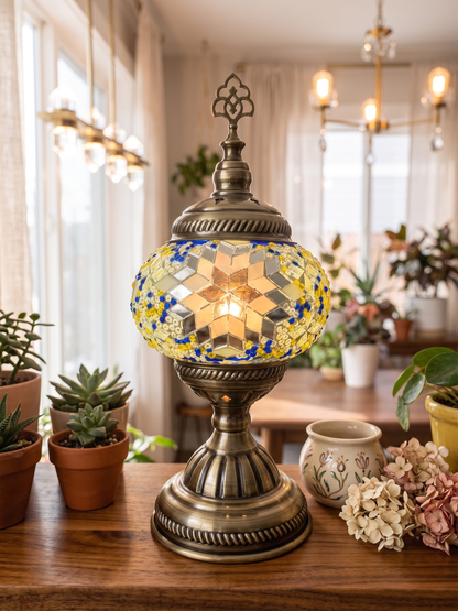 Decorative table lamp with mosaic design on a wooden surface in a home setting.